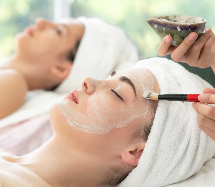 Cropped view of masseur doing back massage to woman in spa